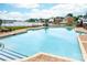 Large community pool surrounded by lounge chairs and overlooking lake at 7220 Swansea Ln, Cornelius, NC 28031