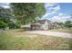 Spacious yard with gravel parking and car port on this charming home's exterior at 813 S Ridge Ave, Kannapolis, NC 28083