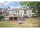 View of home's exterior from the backyard, featuring a wooden deck and grassy area at 813 S Ridge Ave, Kannapolis, NC 28083