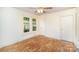 Bedroom showcasing hardwood floors, neutral walls, and natural light from two windows at 813 S Ridge Ave, Kannapolis, NC 28083