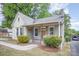 Lovely home showcasing a brick facade, covered porch, and quaint landscaping at 813 S Ridge Ave, Kannapolis, NC 28083