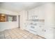 Open kitchen featuring white cabinets, appliances and an opening to the dining room at 813 S Ridge Ave, Kannapolis, NC 28083