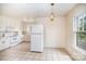 Bright kitchen featuring white cabinets, tile flooring, and plenty of counter space at 813 S Ridge Ave, Kannapolis, NC 28083