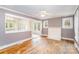 Bright living room featuring a fireplace, hardwood floors, and open layout to the kitchen at 813 S Ridge Ave, Kannapolis, NC 28083