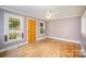 Spacious living room with original hardwood floors, natural light, and a ceiling fan at 813 S Ridge Ave, Kannapolis, NC 28083
