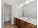Bathroom with double sink vanity, a large mirror, tile flooring, and a bath and shower at 8505 Loxton Cir, Charlotte, NC 28214