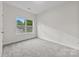 Bedroom features neutral paint, plush carpeting, and a bright window at 8505 Loxton Cir, Charlotte, NC 28214