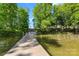 Wooden dock surrounded by a lake and lush trees at 8505 Loxton Cir, Charlotte, NC 28214