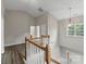 Upstairs landing with views to another room and modern chandelier lighting at 8505 Loxton Cir, Charlotte, NC 28214