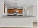 Modern kitchen with granite countertops, wooden cabinets, stainless steel appliances, and a view to the staircase at 8505 Loxton Cir, Charlotte, NC 28214