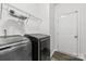 Laundry room featuring a door, black washer and dryer and wire shelving for storage at 8505 Loxton Cir, Charlotte, NC 28214
