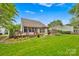 Well-maintained backyard featuring a wooden deck and a pergola, ideal for outdoor gatherings at 8938 Kestral Ridge Dr, Charlotte, NC 28269