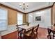 Bright dining area with wood floors, wainscoting, decorative wallpaper, and ample natural light at 8938 Kestral Ridge Dr, Charlotte, NC 28269