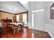 Open concept dining room with wood floors, decorative wallpaper, and a view of the home's front entrance at 8938 Kestral Ridge Dr, Charlotte, NC 28269