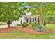 Charming two-story home with stone accents, a well-manicured lawn, and a beautifully landscaped front yard at 8938 Kestral Ridge Dr, Charlotte, NC 28269