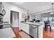 Modern kitchen featuring stainless steel appliances, white cabinets, and a view into the living area at 8938 Kestral Ridge Dr, Charlotte, NC 28269