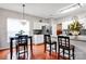 Well-lit kitchen with stainless steel appliances, mosaic backsplash, and breakfast bar seating at 8938 Kestral Ridge Dr, Charlotte, NC 28269