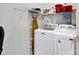 Organized laundry room featuring a washing machine, dryer, and storage shelves at 8938 Kestral Ridge Dr, Charlotte, NC 28269