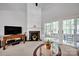 Inviting living room with fireplace, large TV, and sliding doors leading to a patio at 8938 Kestral Ridge Dr, Charlotte, NC 28269