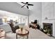 Open floor plan living room with fireplace, TV, and view into the adjacent kitchen at 8938 Kestral Ridge Dr, Charlotte, NC 28269