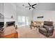 Bright living room with fireplace, ceiling fan, and access to the outside through sliding glass doors at 8938 Kestral Ridge Dr, Charlotte, NC 28269