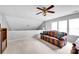Comfortable living room featuring a patterned sofa and a ceiling fan at 8938 Kestral Ridge Dr, Charlotte, NC 28269