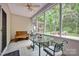 Relaxing screened porch with a glass table and chairs, perfect for outdoor dining at 8938 Kestral Ridge Dr, Charlotte, NC 28269