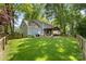 Expansive backyard featuring a covered patio and lush green lawn, perfect for outdoor entertaining at 9238 Deer Spring Ln, Charlotte, NC 28210