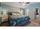 Spacious main bedroom with blue walls, large bed, and en suite bath at 9238 Deer Spring Ln, Charlotte, NC 28210