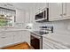 Close up of kitchen featuring stainless steel appliances and white tile backsplash at 9238 Deer Spring Ln, Charlotte, NC 28210