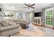 Cozy living room with large windows, hardwood floors and a stylish rug at 9238 Deer Spring Ln, Charlotte, NC 28210