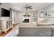 Cozy living room featuring a fireplace, a ceiling fan and hardwood floors at 9238 Deer Spring Ln, Charlotte, NC 28210