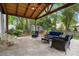 Serene covered patio with cozy seating, surrounded by lush greenery, offering a tranquil outdoor retreat at 9238 Deer Spring Ln, Charlotte, NC 28210