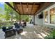 Covered patio with outdoor furniture, lighting, and a television, offering a relaxing backyard atmosphere at 9238 Deer Spring Ln, Charlotte, NC 28210
