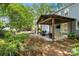 Relaxing outdoor patio with comfortable seating and a covered pergola, perfect for enjoying the backyard scenery at 9238 Deer Spring Ln, Charlotte, NC 28210