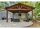 Inviting patio with a pergola, outdoor seating, and a TV, providing a perfect spot for entertaining at 9238 Deer Spring Ln, Charlotte, NC 28210