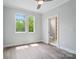 Bright bedroom with large windows and ensuite bathroom with custom shelving at 945 Westbrook Dr # A, Charlotte, NC 28202