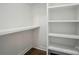 Spacious walk-in closet with wood floors and built in shelving and racks at 945 Westbrook Dr # A, Charlotte, NC 28202