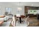 Cozy dining area featuring a round wood table, stylish chairs, and elegant chandelier lighting at 945 Westbrook Dr # A, Charlotte, NC 28202