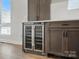Kitchenette with wine refrigerator and stylish cabinetry at 945 Westbrook Dr # A, Charlotte, NC 28202
