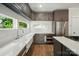 Modern kitchen with gray cabinets, stainless appliances, and white subway tile backsplash at 945 Westbrook Dr # A, Charlotte, NC 28202