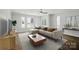 Inviting living room featuring a comfortable sectional sofa, large windows, and modern decor at 945 Westbrook Dr # A, Charlotte, NC 28202