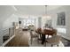 Open concept dining and living area with modern chandelier and hardwood floors at 945 Westbrook Dr # A, Charlotte, NC 28202