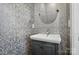 Stylish powder room featuring a silver patterned wallpaper, modern sink, and decorative mirror at 945 Westbrook Dr # A, Charlotte, NC 28202