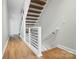 Bright staircase with sleek metal railings and wood treads in a modern, minimalist design at 945 Westbrook Dr # A, Charlotte, NC 28202