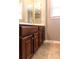 Bathroom featuring a wood vanity with ample storage space and tiled flooring at 9532 Cadman Ct, Cornelius, NC 28031