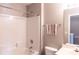 Bright bathroom featuring a white shower-tub combo, toilet, and a large mirror at 9532 Cadman Ct, Cornelius, NC 28031