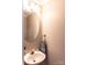 This powder room features a sink, oval mirror and neutral colored walls at 9532 Cadman Ct, Cornelius, NC 28031