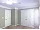 This bedroom features neutral walls, white doors and baseboards and a double door closet at 9532 Cadman Ct, Cornelius, NC 28031