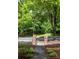 Landscaped walkway leading to the street with trees and wrought iron fence at 9532 Cadman Ct, Cornelius, NC 28031